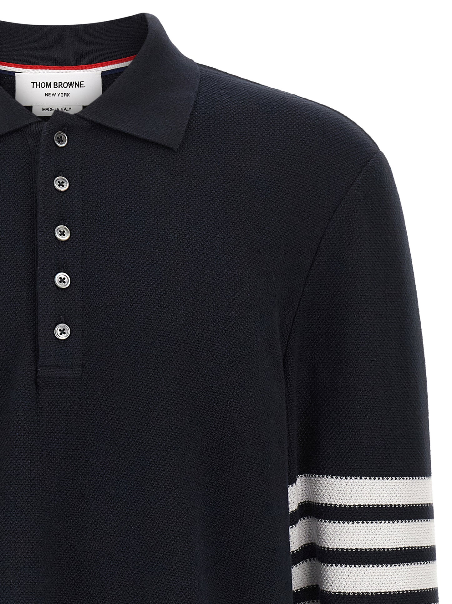This Polo Shirt by Thom Browne for men in cotton blue & signature presents a flawless silhouette, showcasing flawless detailing and a refined for a truly flawless aesthetic.