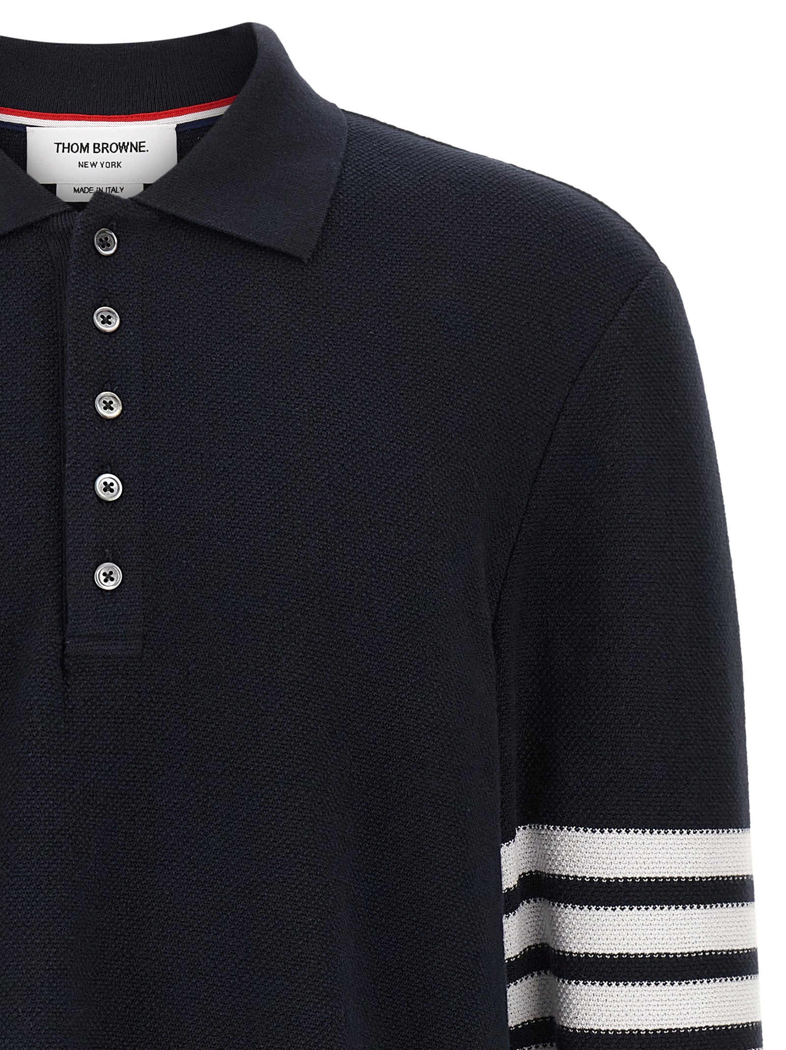 This Polo Shirt by Thom Browne for men in cotton blue & signature presents a flawless silhouette, showcasing flawless detailing and a refined for a truly flawless aesthetic.