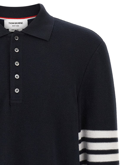 This Polo Shirt by Thom Browne for men in cotton blue & signature presents a flawless silhouette, showcasing flawless detailing and a refined for a truly flawless aesthetic.