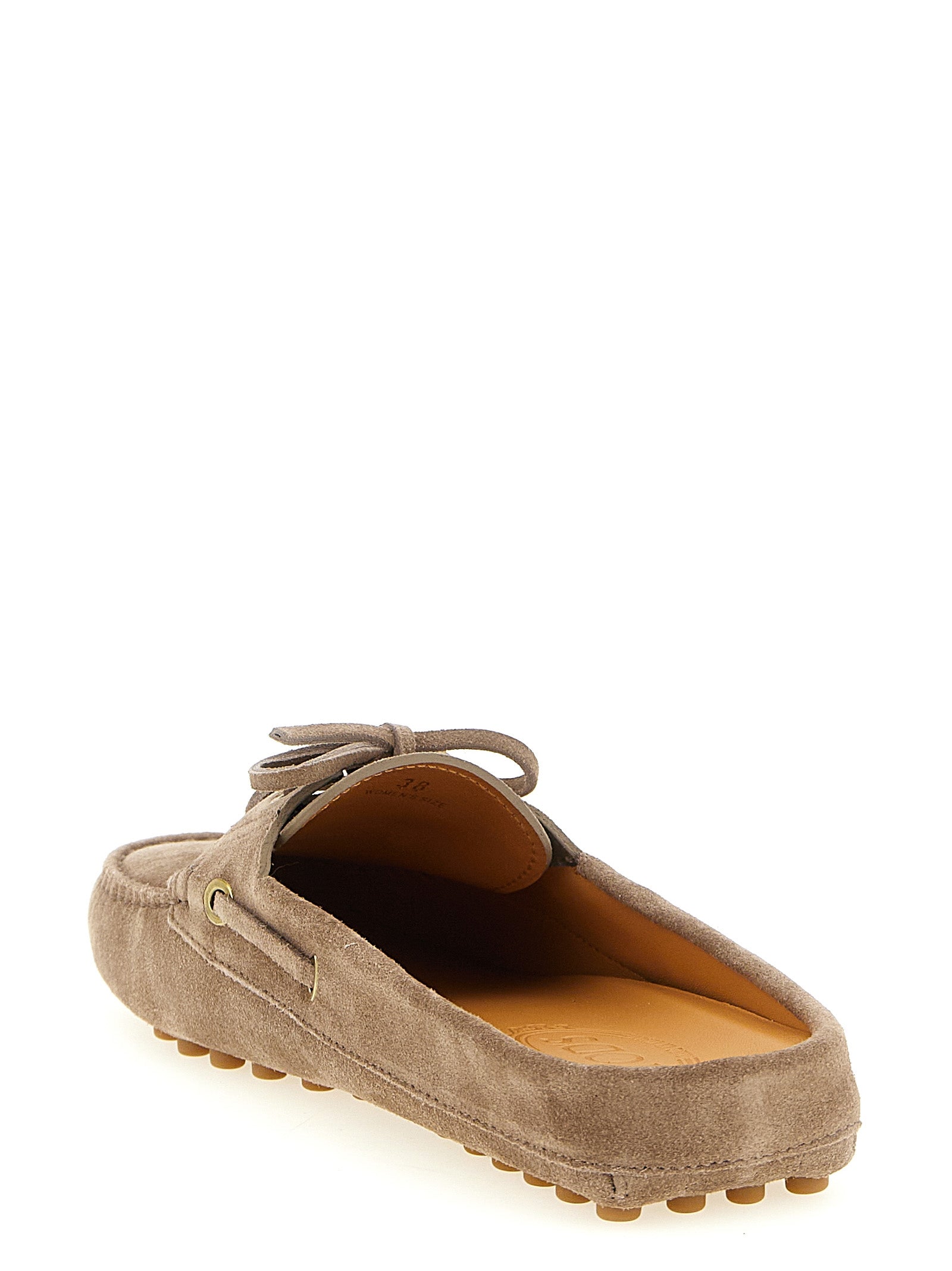 Boat Flat Shoes by Tod's for women in suede calfskin leather beige showcases a dynamic silhouette, artfully capturing Women's Suede Calfskin Leather Boat Flat Shoes through its distinctive and elegant .