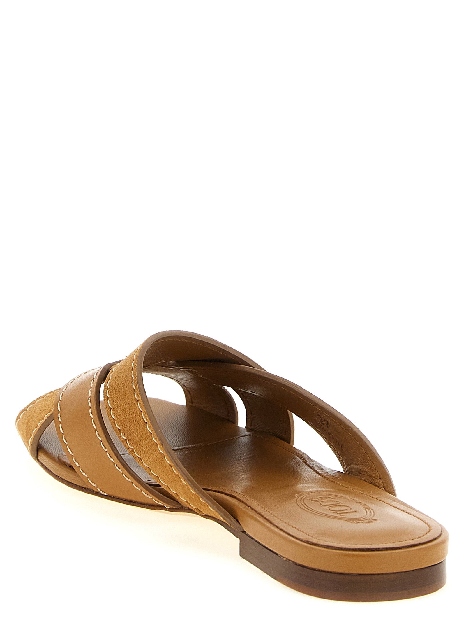 Sliders Sandals Flat Shoes by Tod's for women in calfskin & goat leather beige showcases a dynamic silhouette, artfully capturing Women's Calfskin & Goat Leather Sliders Sandals Flat Shoes through its distinctive and elegant .