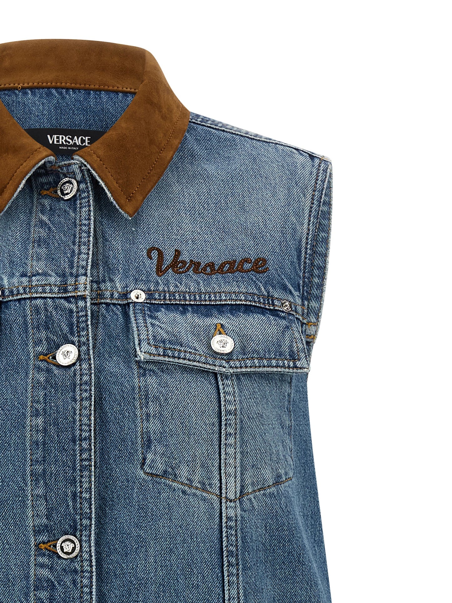 Dress by Versace for women in denim cotton & suede leather blue & signature features an sultry silhouette defined by a and , falling to an sultry short mini for a sultry look.