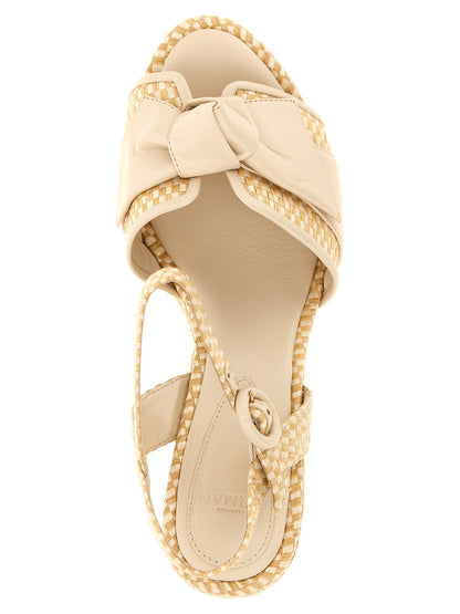Platform Stiletto Ankle Strap Sandals by Alexandre Birman for women in raffia & bos taurus cowhide leather beige & natural presents a sculptural silhouette, showcasing the Women's Raffia & Bos Taurus Cowhide Leather Platform Stiletto Ankle Strap Sandals design with a sculptural stiletto platform and for a premium look.
