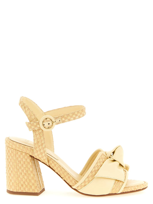 Platform Ankle Strap Sandals by Alexandre Birman for women in raffia & bos taurus cowhide leather bicolour, natural & yellow presents a sculptural silhouette, showcasing the Women's Raffia & Bos Taurus Cowhide Leather Platform Ankle Strap Sandals design with a sculptural platform and for a premium look.