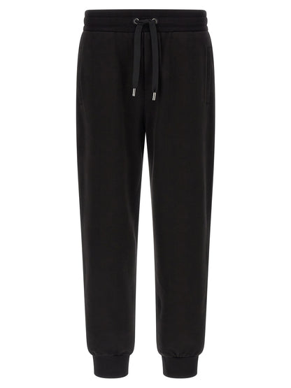 Joggers by Dolce & Gabbana for men in cotton black presents a refined pantology silhouette, artfully defined by a refined pantology , long, and a sophisticated .