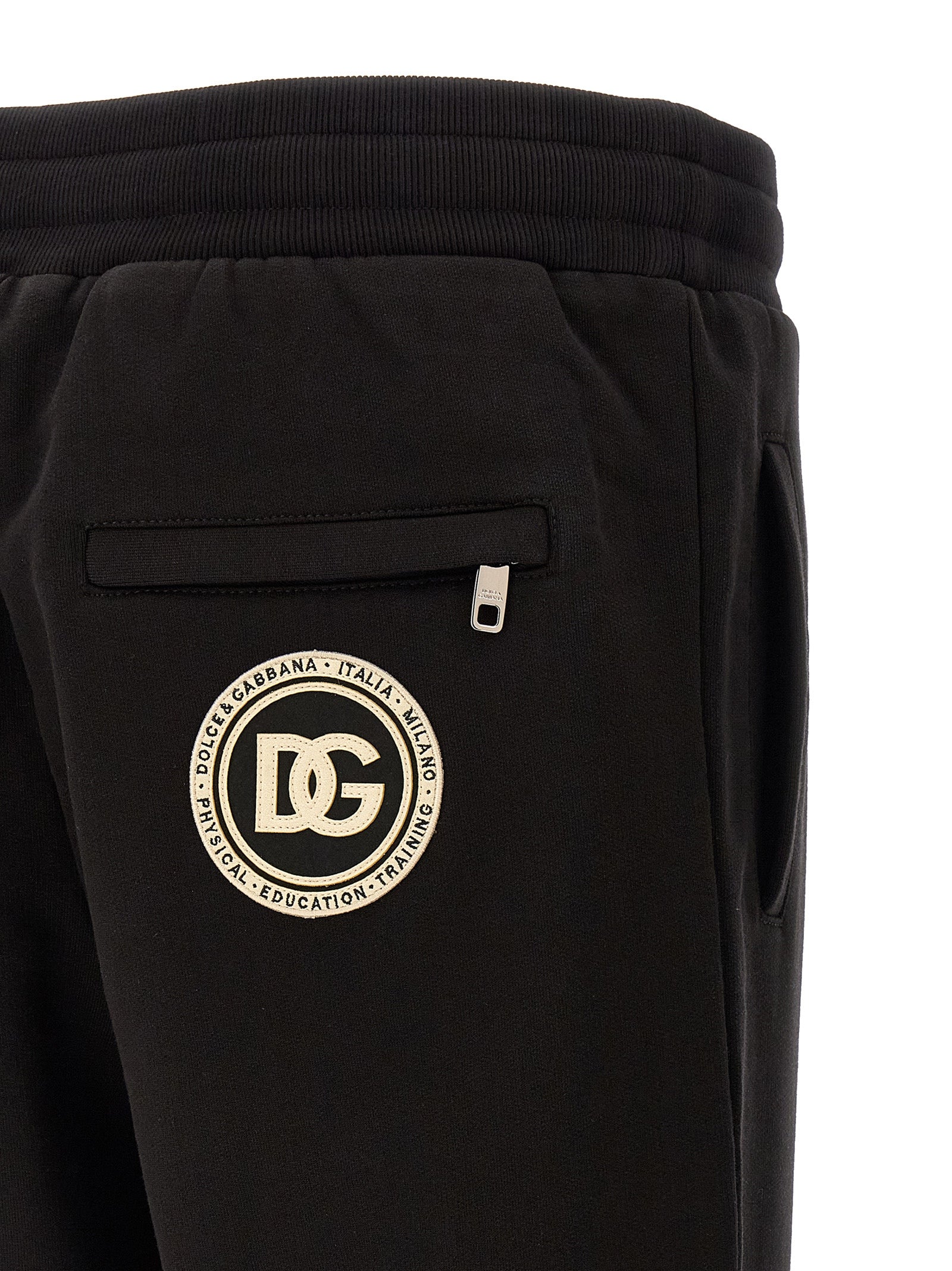 Joggers by Dolce & Gabbana for men in cotton black presents a tailored silhouette, showcasing a tailored and long cut with a refined for a truly tailored aesthetic.