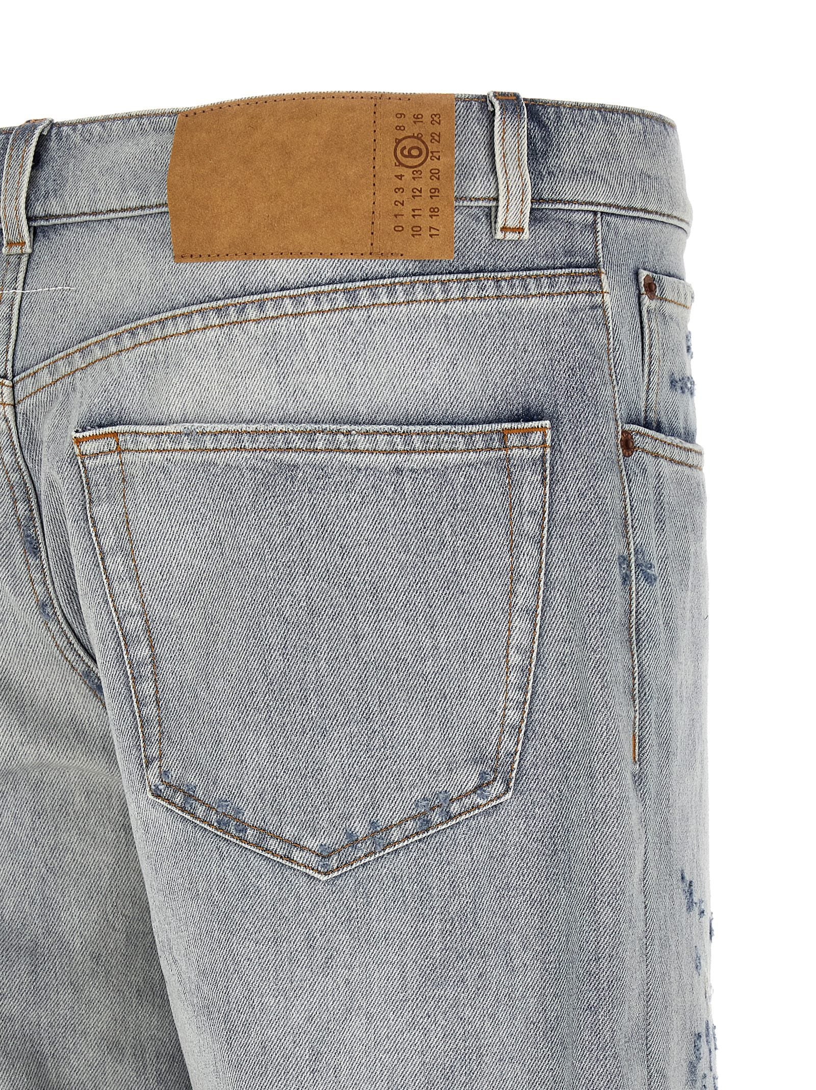 Jeans by MM6 Maison Margiela for men in denim cotton light-blue, white & signature features a refined silhouette with a refined straight-leg, relaxed-fit & wide, defined by a and a refined long for a refined finish.