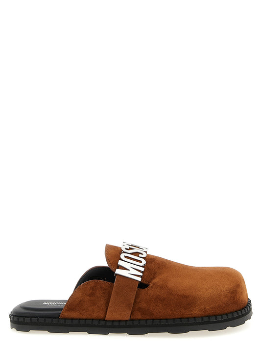 Clogs Flat Shoes by Moschino for women in tu & suede calfskin leather brown features an statuesque silhouette from the Women's TU & Suede Calfskin Leather Clogs Flat Shoes collection, showcasing a and a statuesque for a statuesque look.