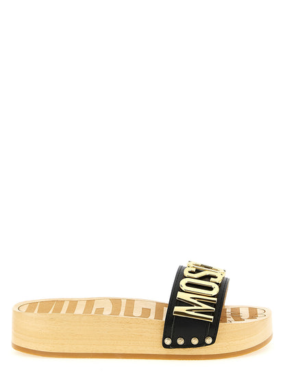 Sliders Sandals Flat Shoes by Moschino for women in calfskin leather black & gold presents a impeccable silhouette as Women's Calfskin Leather Sliders Sandals Flat Shoes, artfully designed with a and a impeccable for a refined, upscale finish.