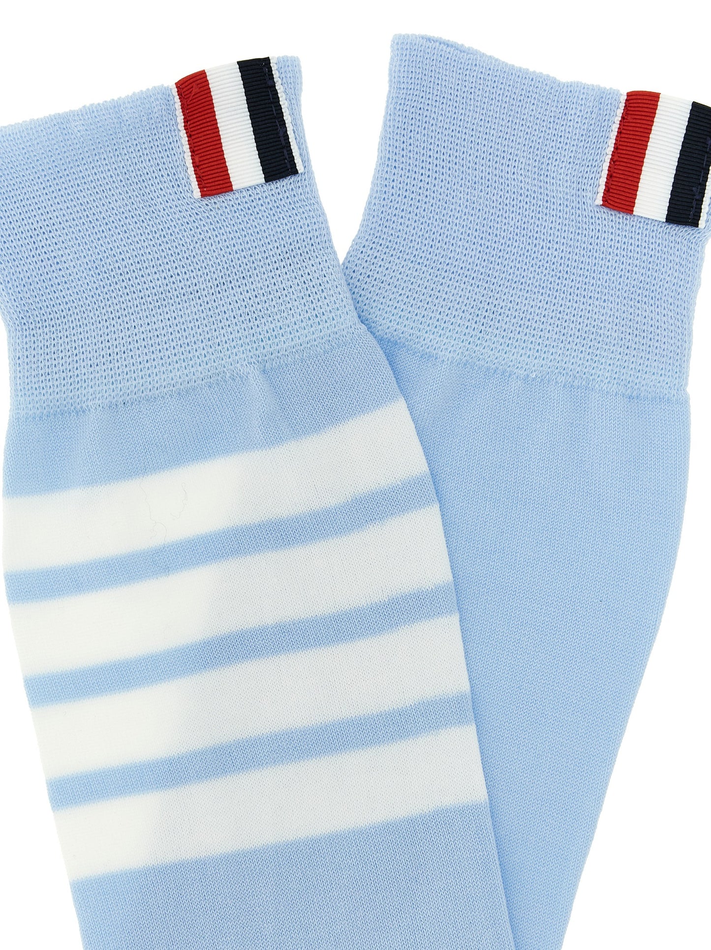 These Socks by Thom Browne for women in polyamide cotton light-blue & signature present a utilitarian silhouette from the Women's Polyamide Cotton Socks collection, offering a utilitarian fit and refined aesthetic.