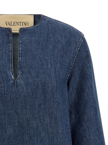Dress by Valentino Garavani for women in denim cotton blue features a dramatic silhouette, showcasing an elegant v-neck neckline and that flows into a dramatic short.