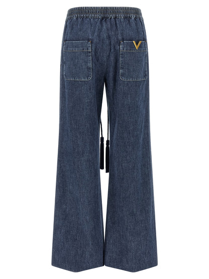 Jeans by Valentino Garavani for women in denim cotton blue features a polished silhouette with a polished flared & wide, reaching a polished long and finished with a polished .