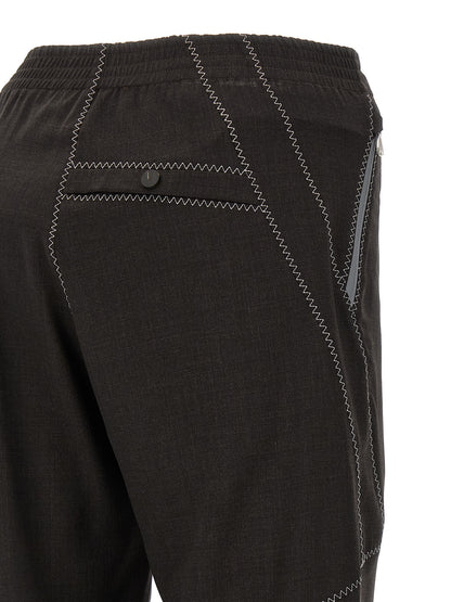 Trousers by Kiko Kostadinov for men in virgin wool brown features a sculptural silhouette, showcasing a sculptural straight-leg and long with a sophisticated for a sculptural finish.