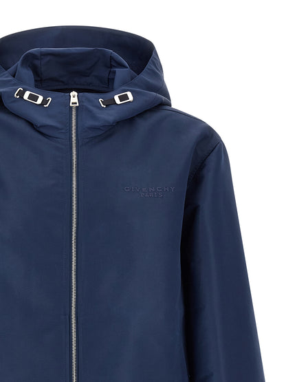 Hooded Windbreaker Jacket by Givenchy for men in polyester blue presents a resilient silhouette, artfully detailed with a sophisticated hooded high-neck neckline and functional pockets, hooded & windproof for a resilient finish.