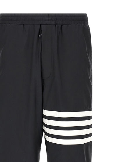Joggers by Thom Browne for men in polyamide & polyester blue & print features a polished silhouette with a polished straight-leg, reaching a polished long and finished with a polished .