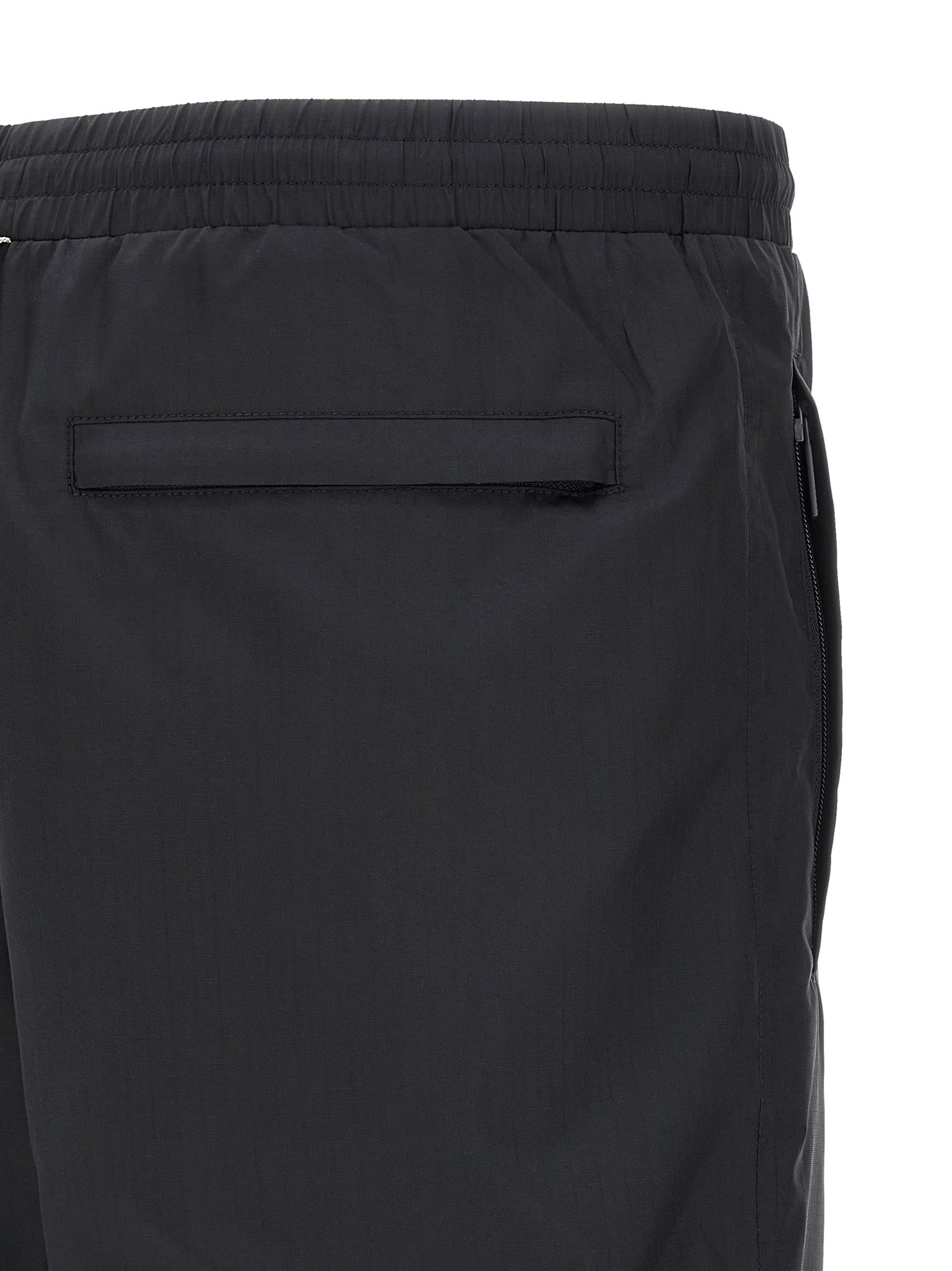 Joggers by Thom Browne for men in polyamide & polyester blue & print presents a refined pantology silhouette, artfully defined by a refined pantology straight-leg, long, and a sophisticated .