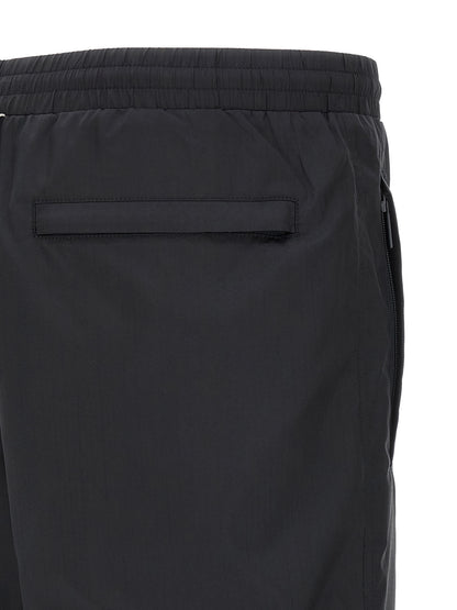 Joggers by Thom Browne for men in polyamide & polyester blue & print presents a refined pantology silhouette, artfully defined by a refined pantology straight-leg, long, and a sophisticated .