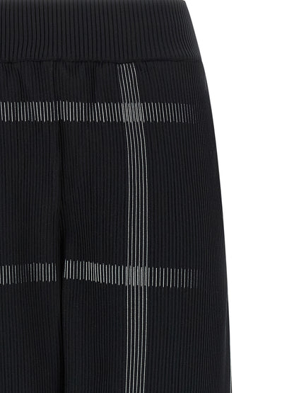 Casual Pants by PLEATS PLEASE ISSEY MIYAKE for women in polyester & nylon black & patterned presents a tailored silhouette, showcasing a tailored wide and long cut with a refined for a truly tailored aesthetic.