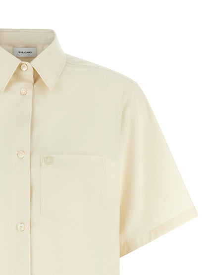 Blouse by Ferragamo for women in cotton & silk beige, pearl & signature features an architectural silhouette with a refined and elegant asymmetric neckline for a architectural look.