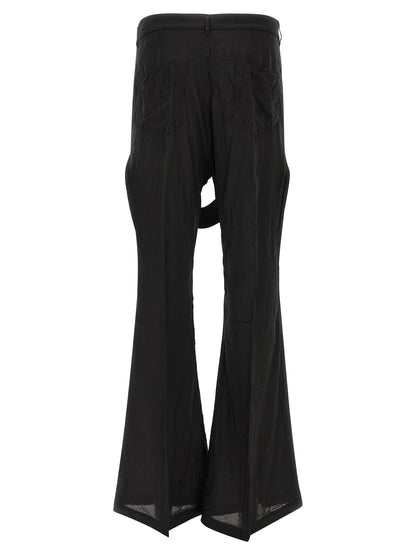 Trousers by Rick Owens for men in cupro & copper black & copper presents a perennial silhouette, meticulously tailored with a flared & wide cut, long finish, and an elegant high rise.