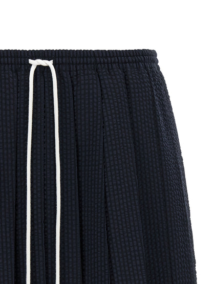 Skirt by Thom Browne for women in wool blue & striped showcases a sultry silhouette, elegantly defined by its mini long and the sophisticated sultry design of the Women's Pleated Flared Wool Mini Long Skirt.