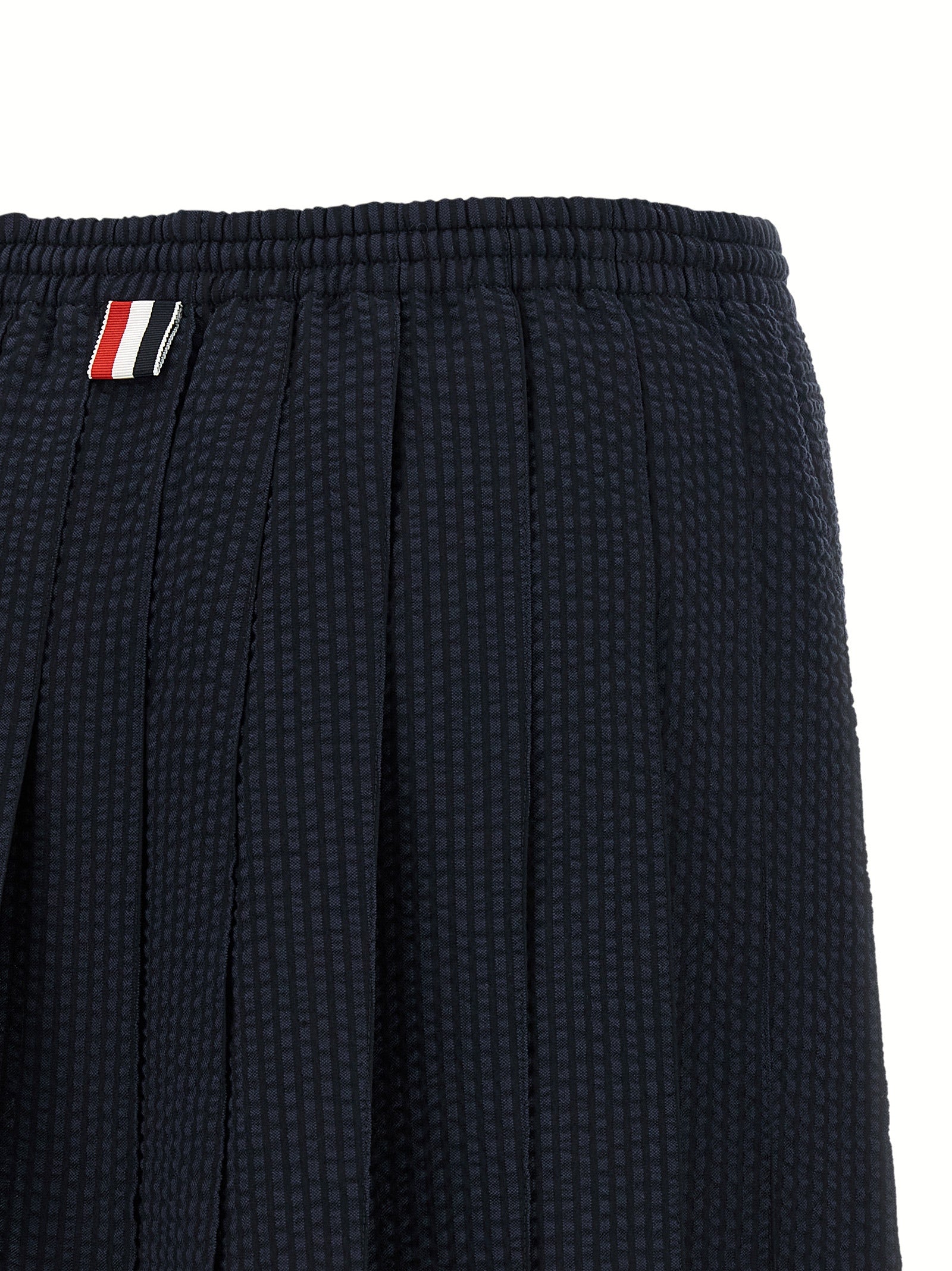 Skirt by Thom Browne for women in wool blue & striped features an relaxed-yet-refined silhouette that elegantly showcases the Women's Pleated Flared Wool Mini Long Skirt design and sophisticated mini long.