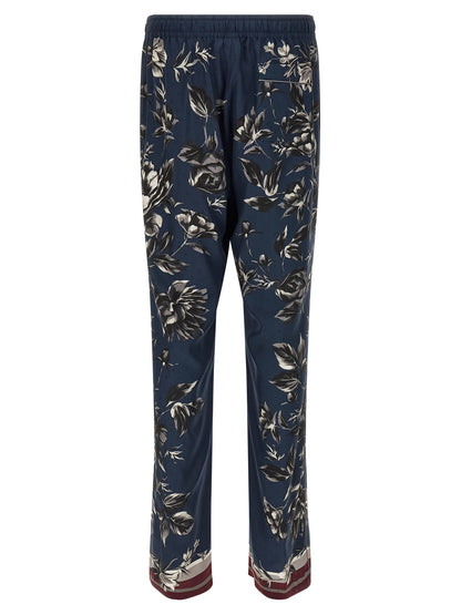 Trousers by Dolce & Gabbana for men in silk twill blue & print presents a perennial silhouette, meticulously tailored with a straight-leg & wide cut, long finish, and an elegant .