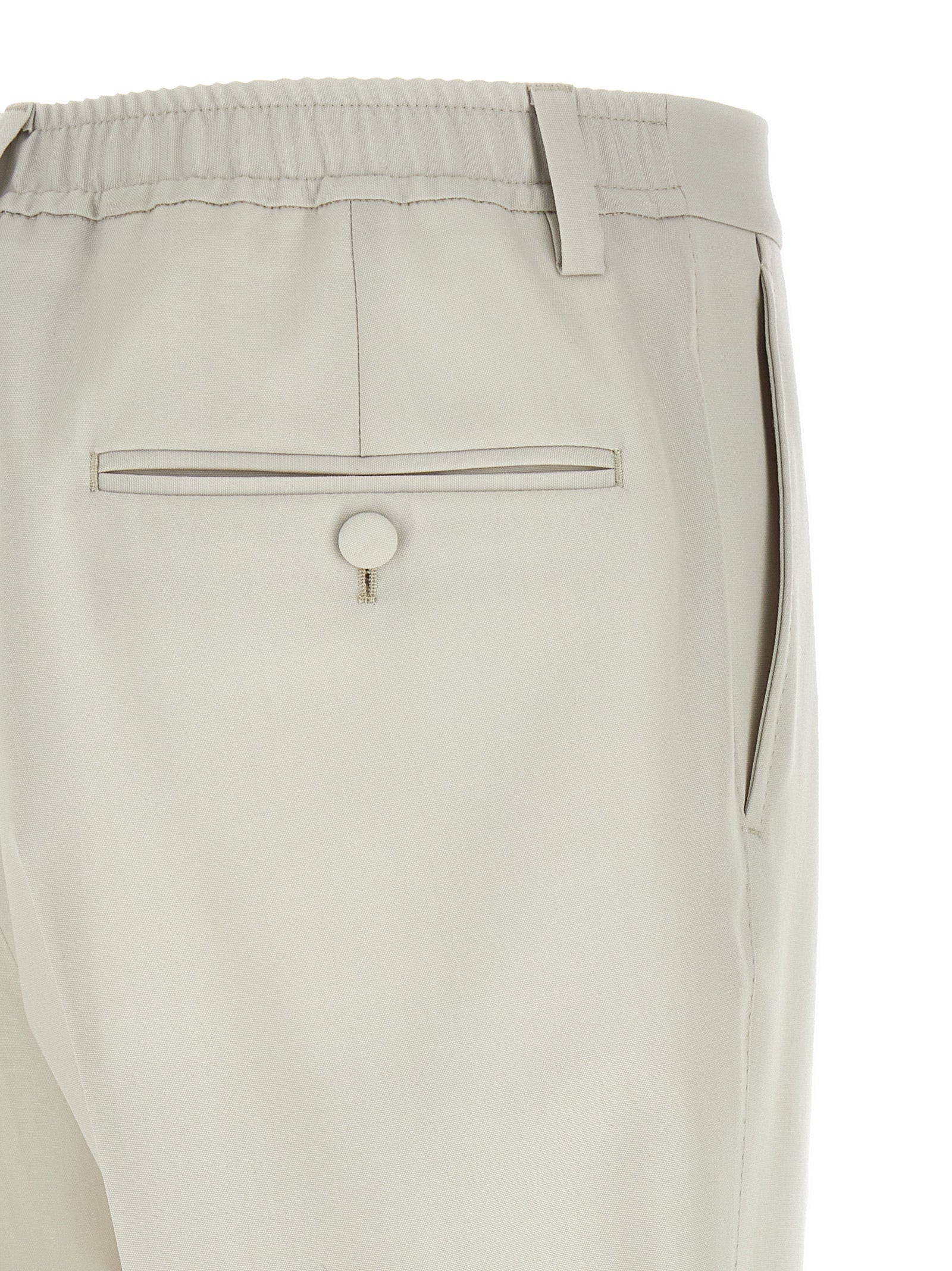 Trousers by Dolce & Gabbana for men in virgin wool beige presents a perennial silhouette, meticulously tailored with a straight-leg cut, long finish, and an elegant .