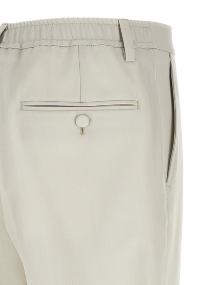 Trousers by Dolce & Gabbana for men in virgin wool beige presents a perennial silhouette, meticulously tailored with a straight-leg cut, long finish, and an elegant .