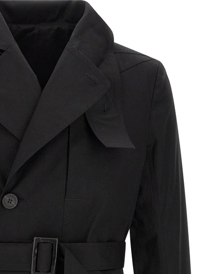 Trench Coat by Rick Owens for men in stretch cotton black presents an sculptural silhouette, artfully detailed with a sculptural and functional insulated for a truly sculptural finish.