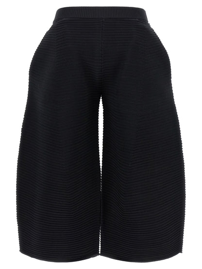 Trousers by Issey Miyake for women in polyester & nylon black features a sculptural silhouette, showcasing a sculptural wide & cropped and cropped with a sophisticated for a sculptural finish.