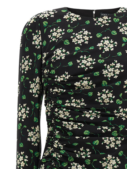 Dress by Dolce & Gabbana for women in synthetic silk black & print presents a sinuous silhouette, showcasing a sophisticated crew split neckline and detailed with a sinuous midi for a refined finish.