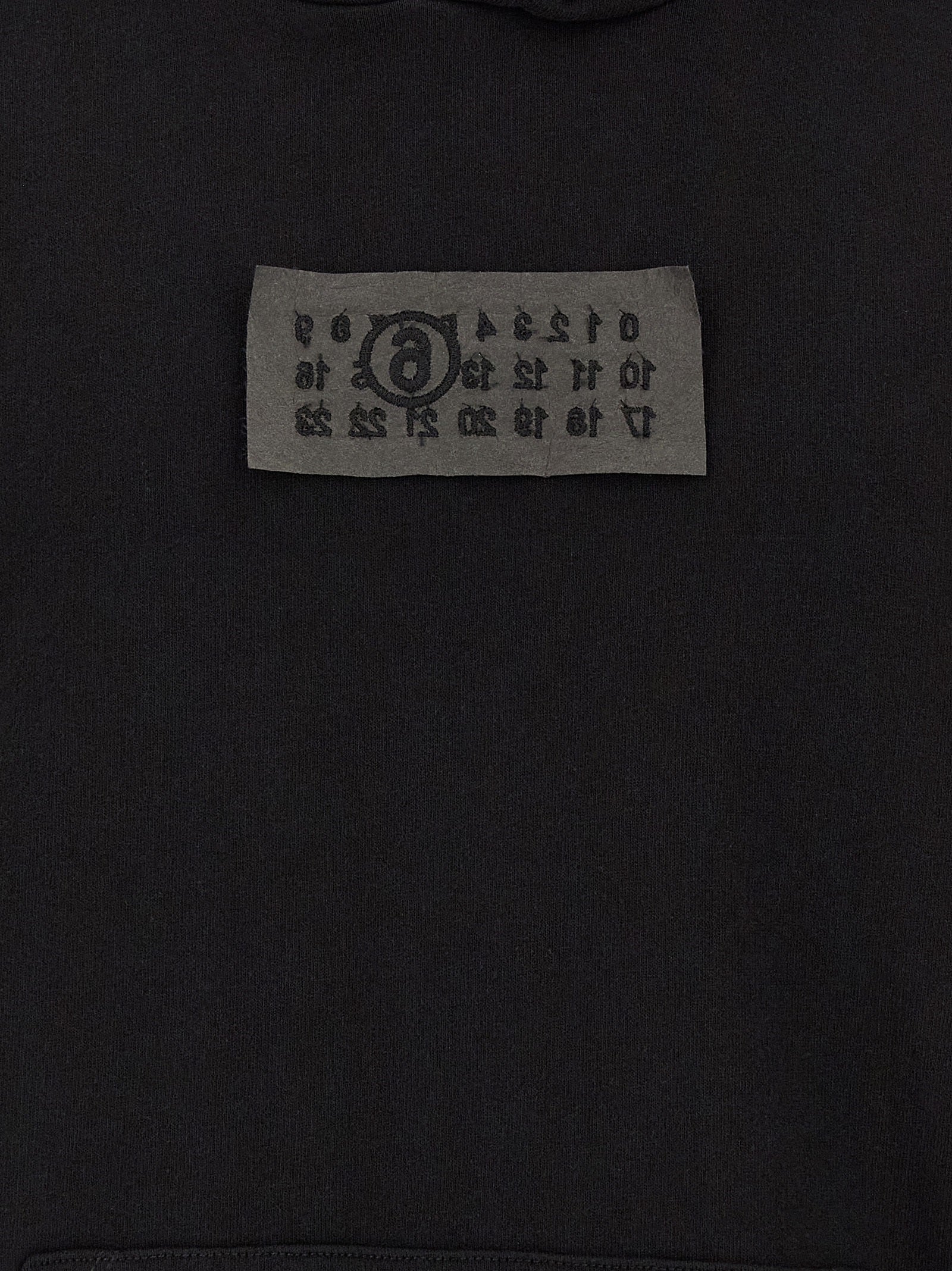 Sweatshirt Hoodie by MM6 Maison Margiela for men in cotton black features a slouchy chic silhouette, detailed with a slouchy chic and a signature for an elevated aesthetic.