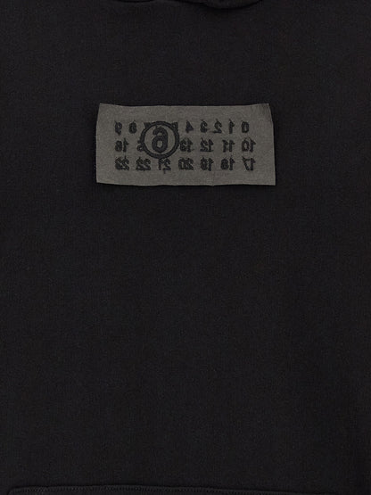Sweatshirt Hoodie by MM6 Maison Margiela for men in cotton black features a slouchy chic silhouette, detailed with a slouchy chic and a signature for an elevated aesthetic.