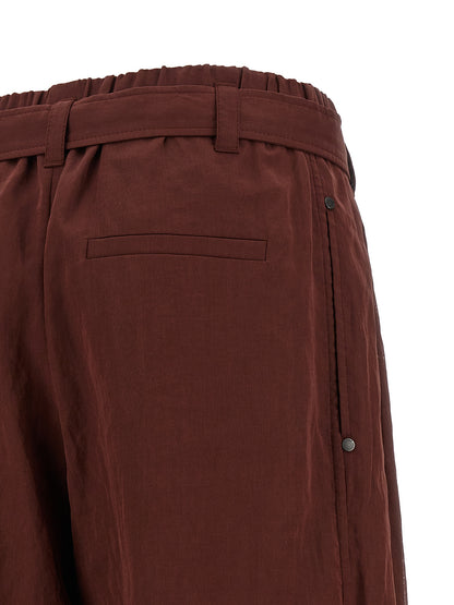 Trousers by Brunello Cucinelli for women in cotton & silk bordeaux & transparent features a tailored silhouette with a tailored flared & wide, defined by its long and a sophisticated high rise.