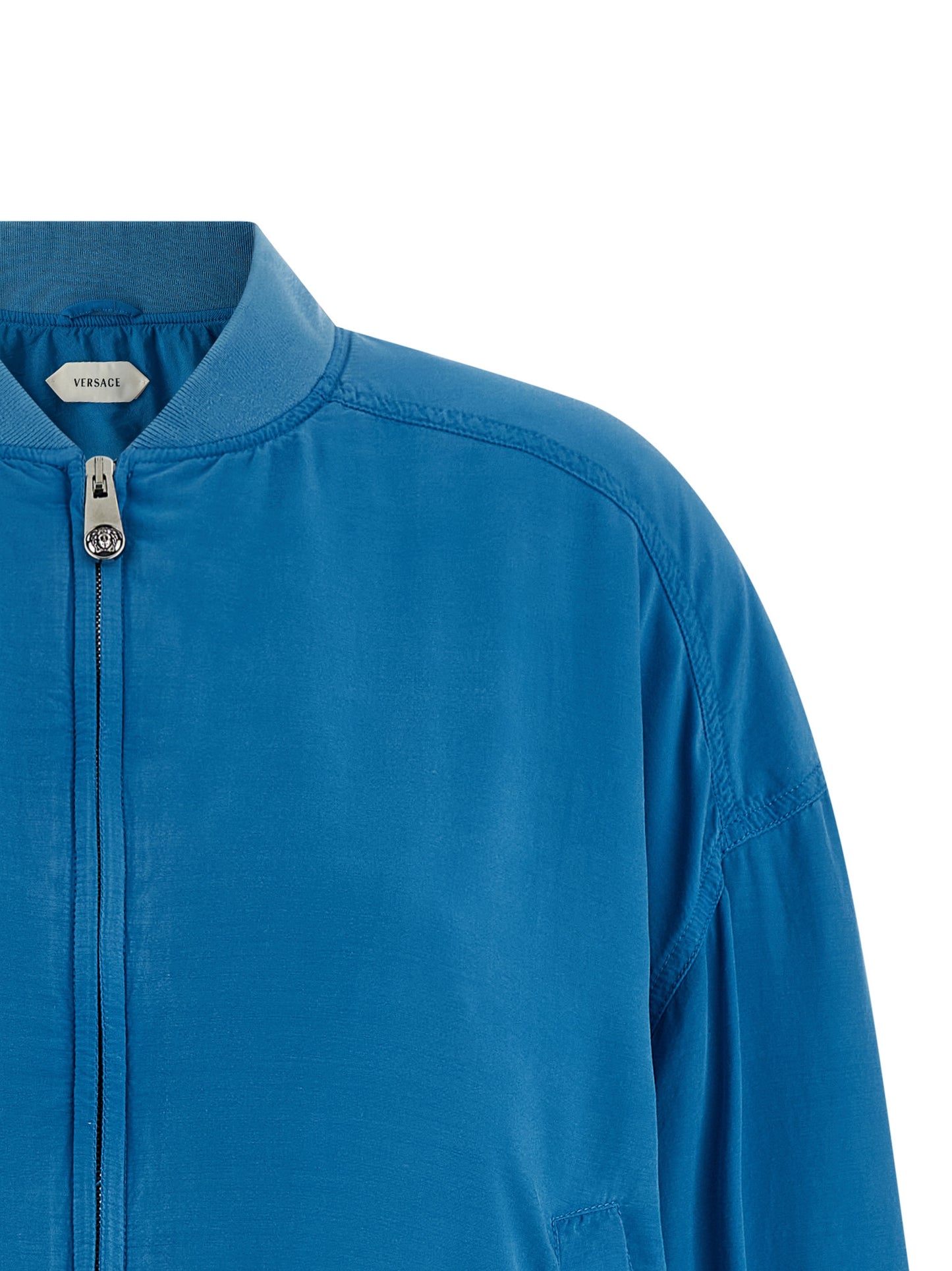 Bomber Jacket by Versace for women in silk light-blue showcases a bohemian silhouette, artfully detailed with a bohemian high-neck neckline and signature pockets for a truly bohemian finish.