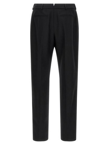 Trousers by Saint Laurent for men in wool black presents a perennial silhouette, meticulously tailored with a cut, long finish, and an elegant mid rise.
