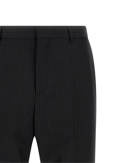 Trousers by Saint Laurent for men in wool black features a sculptural silhouette, showcasing a sculptural and long with a sophisticated mid rise for a sculptural finish.