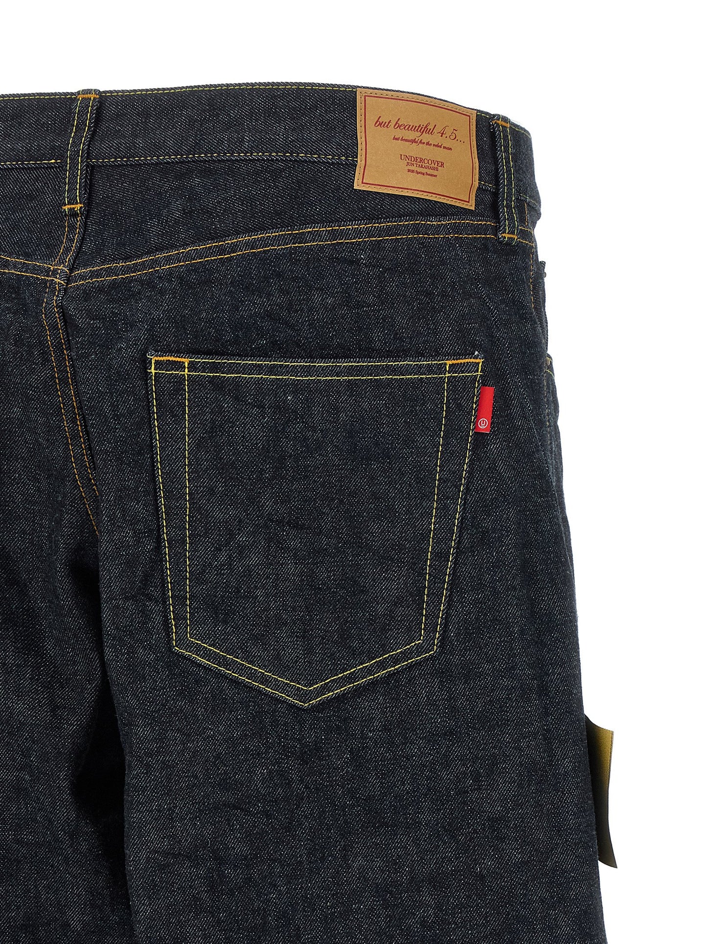 Jeans by Undercover for men in cotton denim blue features a polished silhouette with a polished wide, reaching a polished long and finished with a polished .