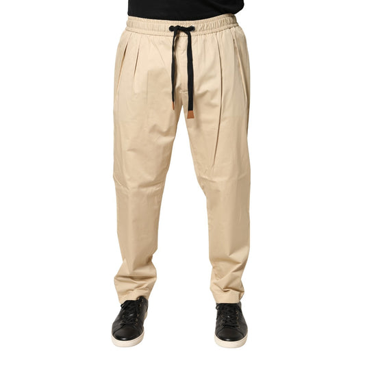 Joggers by Dolce & Gabbana for men in stretch cotton beige presents a tailored silhouette, showcasing a tailored skinny & regular-fit and long cut with a refined mid rise for a truly tailored aesthetic.