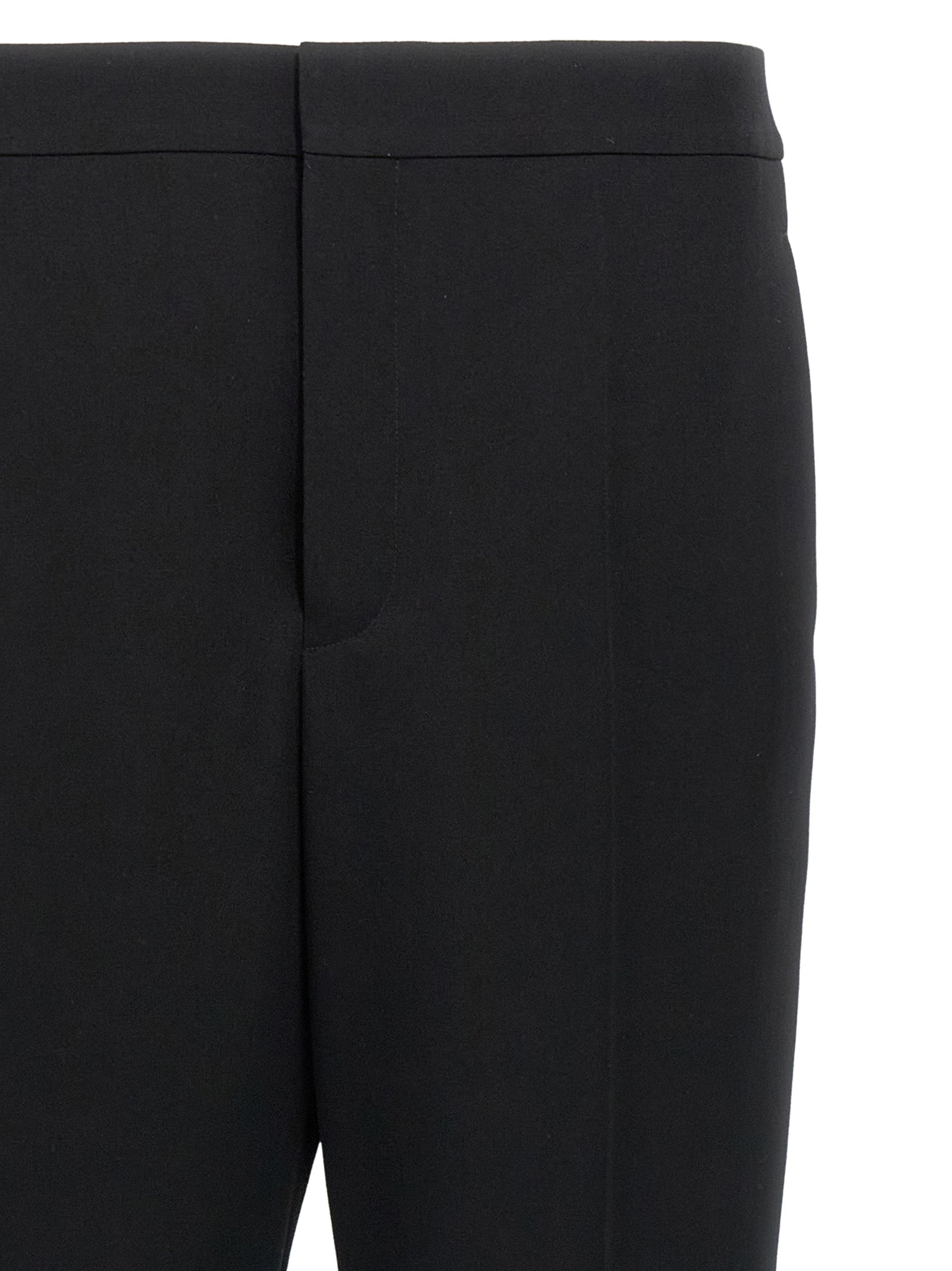 Trousers by Saint Laurent for men in wool black features a sculptural silhouette, showcasing a sculptural and long with a sophisticated for a sculptural finish.