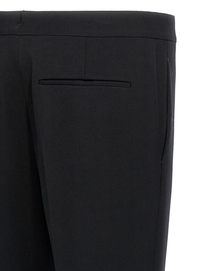 Trousers by Saint Laurent for men in wool black features an on trend silhouette, showcasing a sophisticated with a long and for an on trend finish.