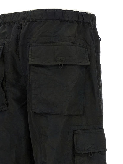 Cargo Pants by Comme Des Garçons for men in nylon fabric black presents a on trend silhouette, artfully finished with a on trend straight-leg & wide, long, and for a sophisticated look.