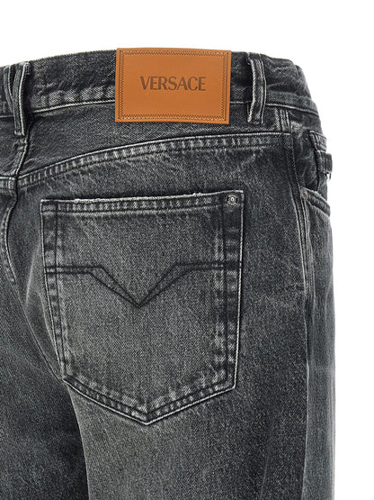 Jeans by Versace for men in cotton denim gray & signature features a polished silhouette with a polished straight-leg & wide, reaching a polished long and finished with a polished .
