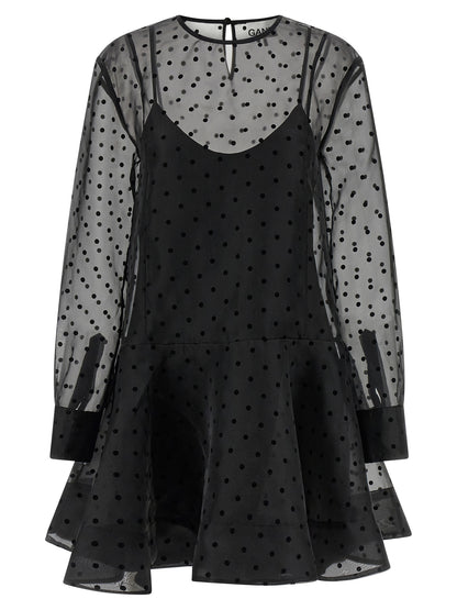 Dress by Ganni for women in polyester & viscose black & transparent features a dramatic silhouette, showcasing an elegant and that flows into a dramatic maxi short mini.