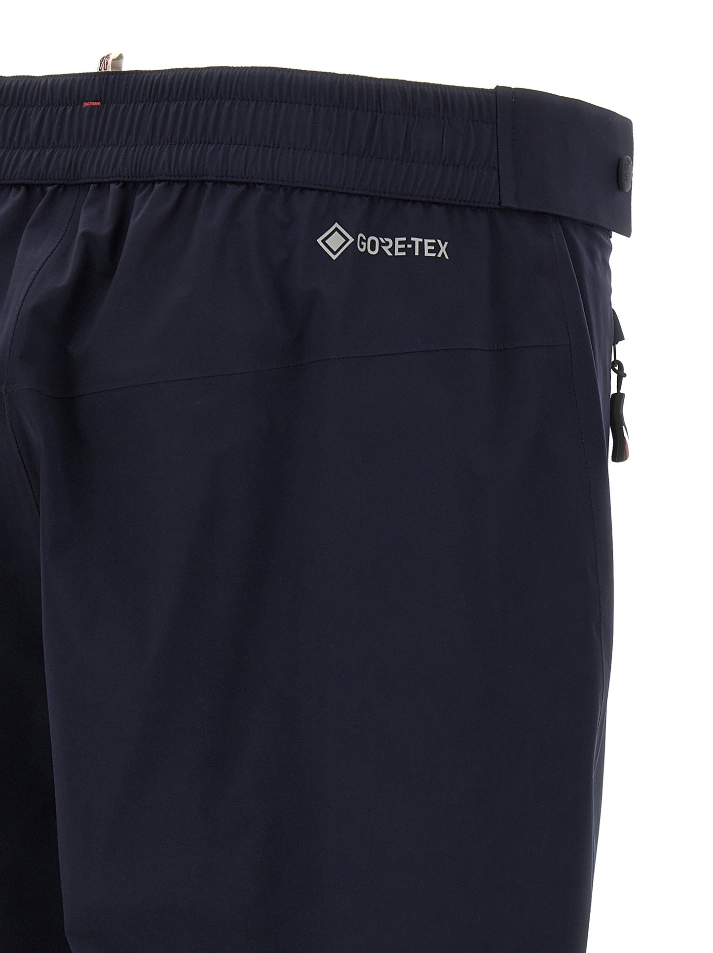 Joggers by Moncler Grenoble for men in polyamide blue presents a tailored silhouette, showcasing a tailored and long cut with a refined for a truly tailored aesthetic.