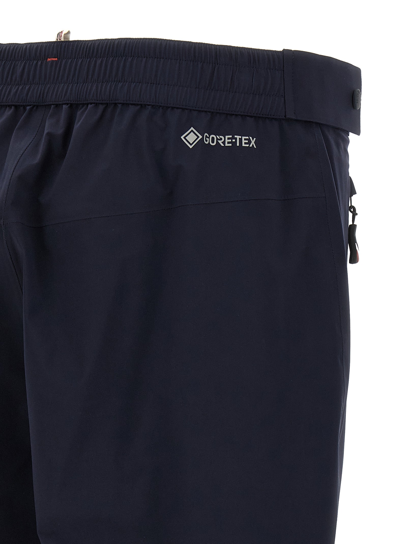 Joggers by Moncler Grenoble for men in polyamide blue presents a tailored silhouette, showcasing a tailored and long cut with a refined for a truly tailored aesthetic.