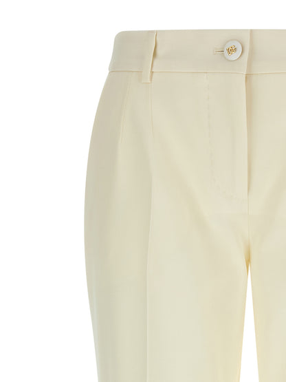 Trousers by Dolce & Gabbana for women in virgin wool white presents a perennial silhouette, meticulously tailored with a straight-leg cut, long finish, and an elegant .