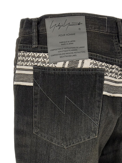 Jeans by Yohji Yamamoto for men in denim cotton black & jacquard presents a refined pantology silhouette, artfully defined by a refined pantology tapered-leg, long, and a sophisticated mid rise.