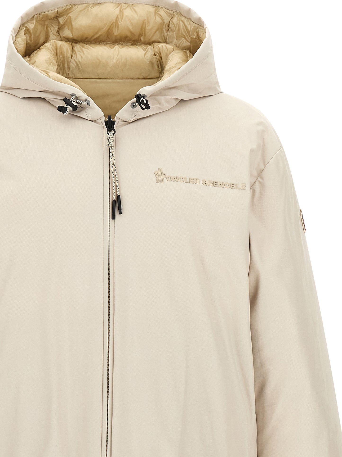 This Hooded Puffer Jacket by Moncler Grenoble for men in nylon beige exhibits a edgy silhouette, meticulously detailed with functional hooded, insulated & windproof and a edgy hooded neckline for a edgy finish.